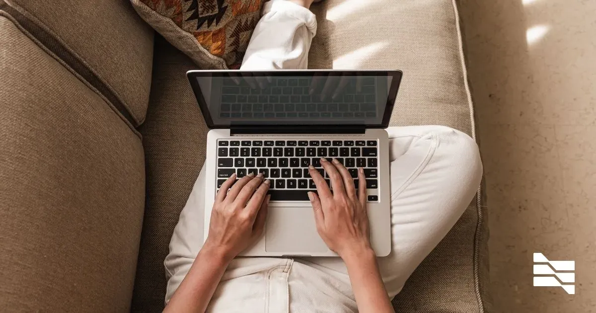 Top-down view of a freelancer working on a laptop, indicative of the essential tools and platforms for successful freelance work.