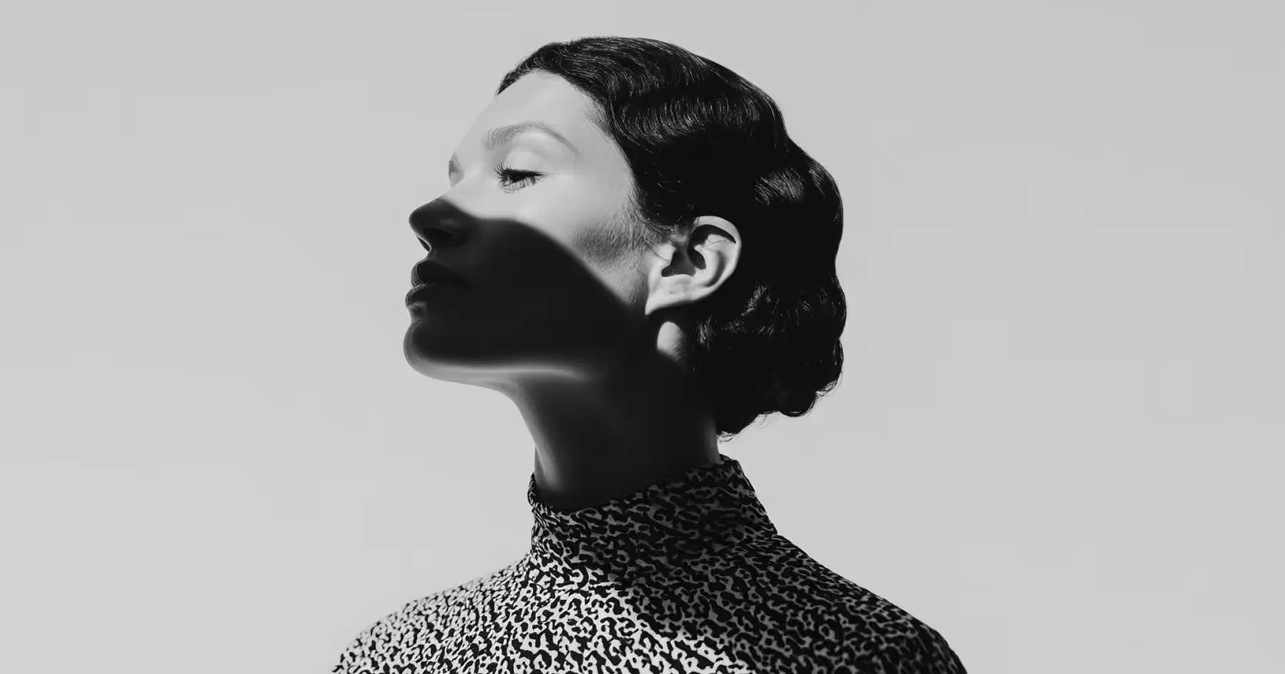 A black-and-white profile portrait of a woman