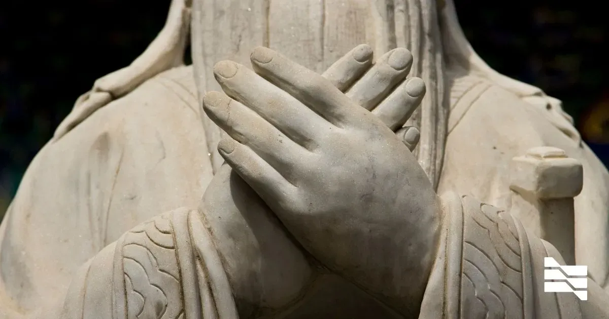 Close-up of marble sculpture hands, symbolizing the protection of freelancers' intellectual property.