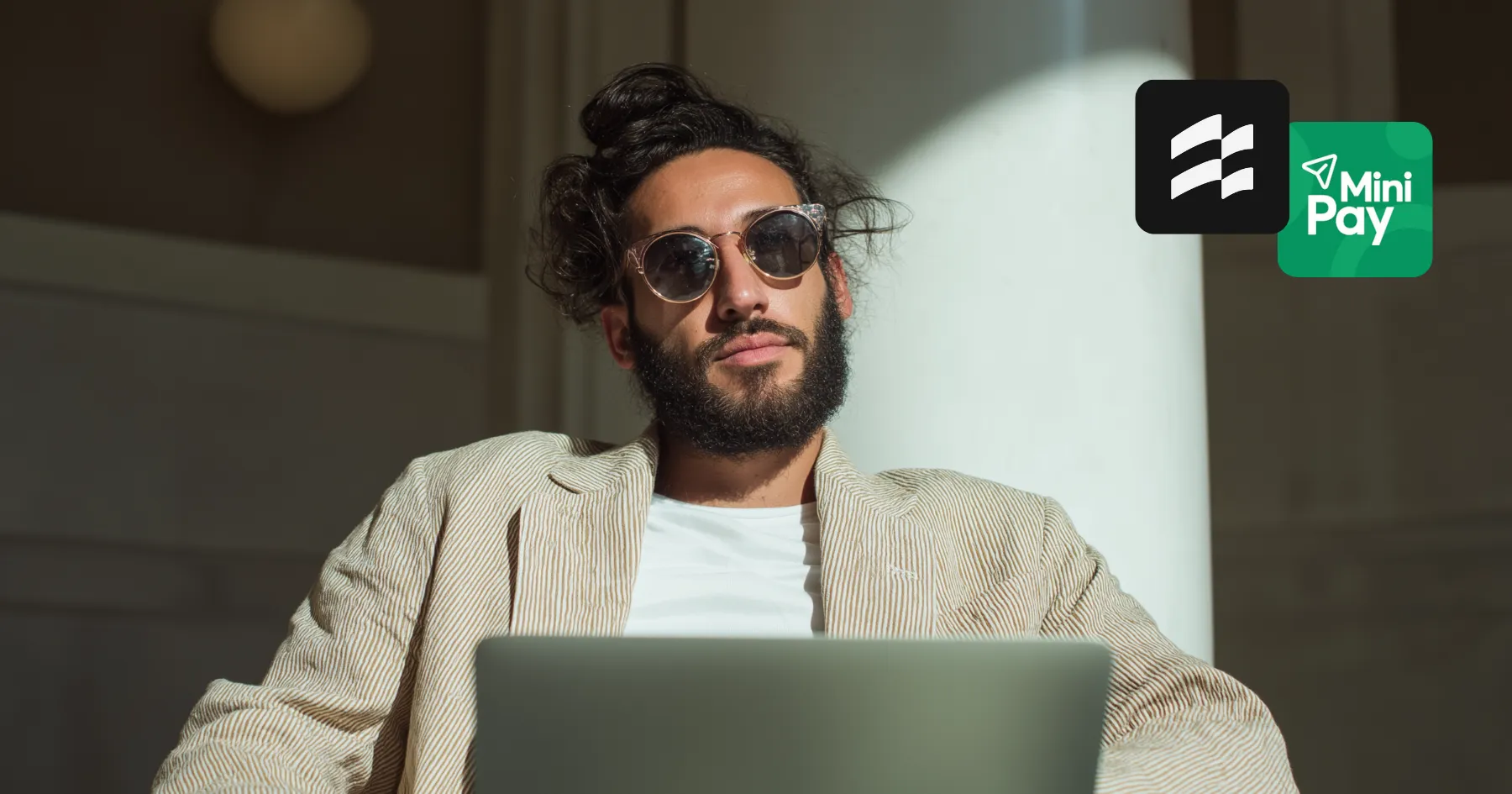 A man in sunglasses using a laptop, with the MiniPay logo
