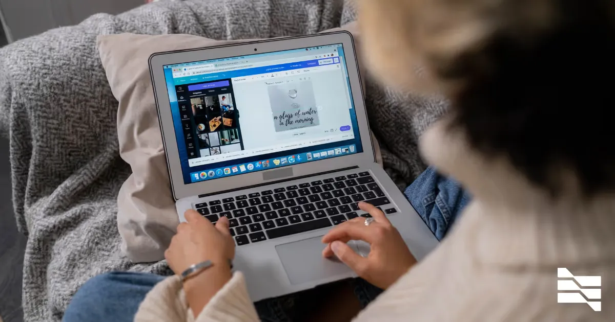 A person editing a design on a laptop, seen over the shoulder
